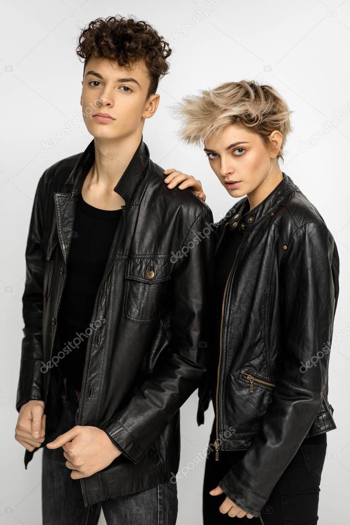 Sexy fashionable couple in black leather jacket isolated on white background