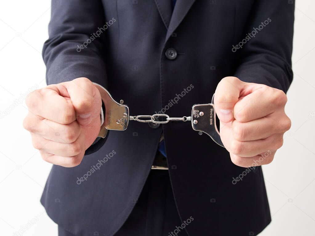 Japanese male businessman being arrested