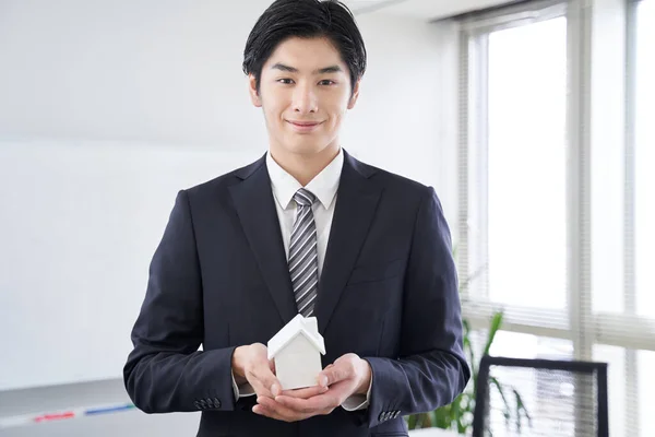 Japanese male businessman with a white house object