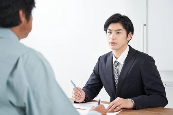 Japansk Mannlig Selger Som Diskuterer Bygging – stockfoto