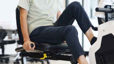 Asian elderly people exercising on recumbent bike