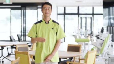 Asian care worker giving a tour at a nursing home