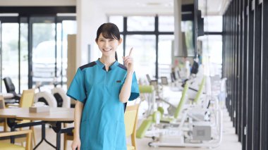 Asian care worker pointing at care facility