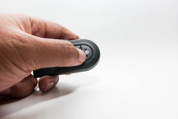 Man with car keys (remote), isolated on white background