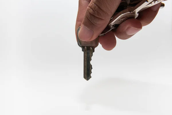 A hand holding a metal key — Stock Photo, Image