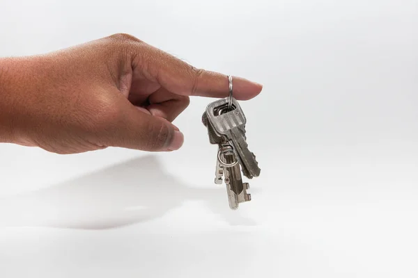 A hand holding a metal key — Stock Photo, Image