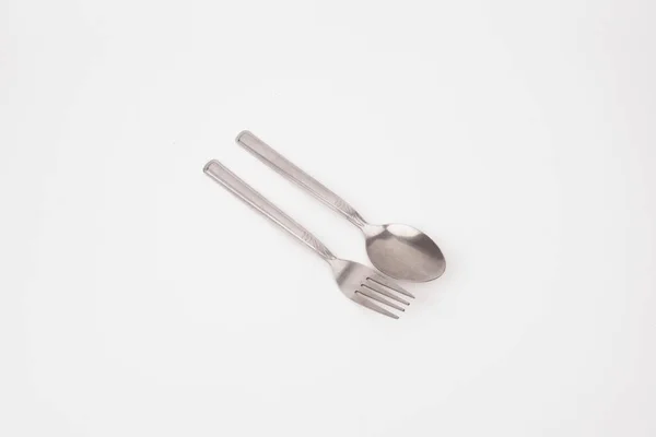 Tenedor de acero y cuchara de plata aislados sobre fondo blanco —  Fotos de Stock