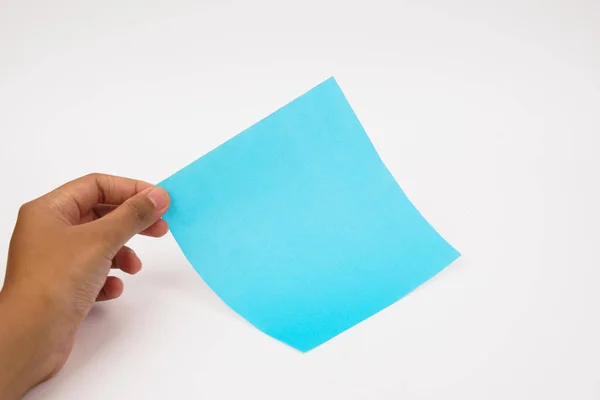 Une main tient du papier bleu vierge sur un fond blanc . — Photo