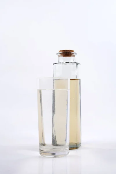 Clean water in glass and dirty water in bottle glass on white background — Stock Photo, Image