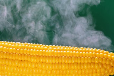 Yeşil bir arka plan üzerine haşlanmış mısır