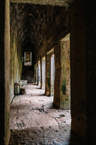Corridor in the ruins of the Ankgor Thom Buddhist temples in Cambodia - Unesco World Heritage Site 1992 - Vertical image