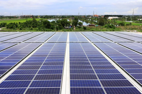 Solar PV Rooftop System on Warehouse Roof with Countryside Background in Thailand