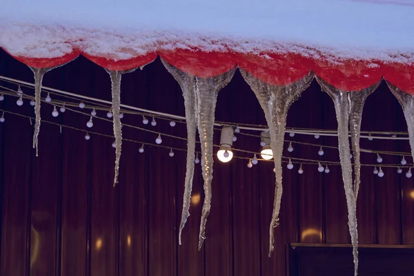 hanging icicles from the roof, lit by a garland of light bulbs