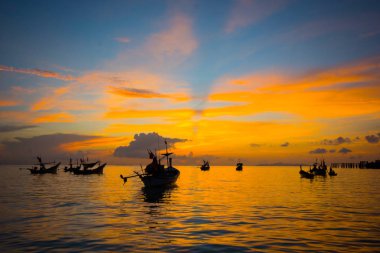 Harika alacakaranlık gökyüzü bulut deniz kenarında akşam saat içinde bağlantılı siluet balıkçı tekneleri ile