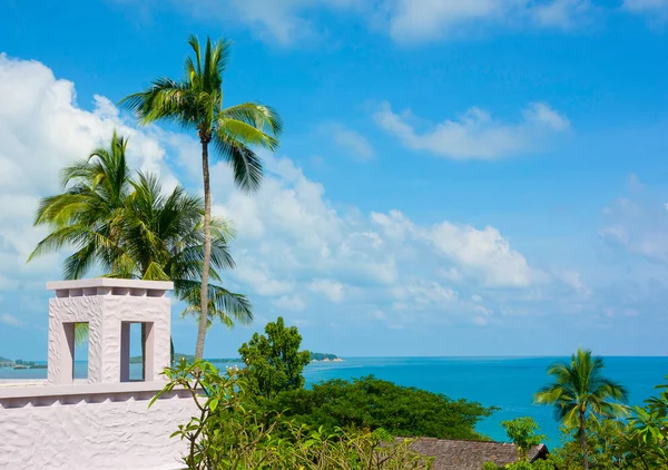 SEASIDE HOUSE WITH BEAUTIFUL VIEW COCONUT PALM TREE AND CLEAR BLUE SKY IN SUNNY DAY TIME