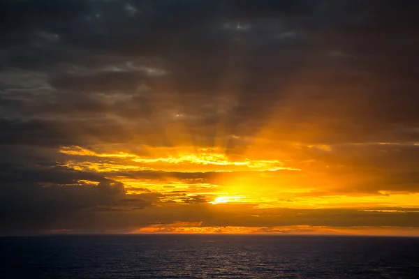 Sea sunset with sun in horizon and yellow sky