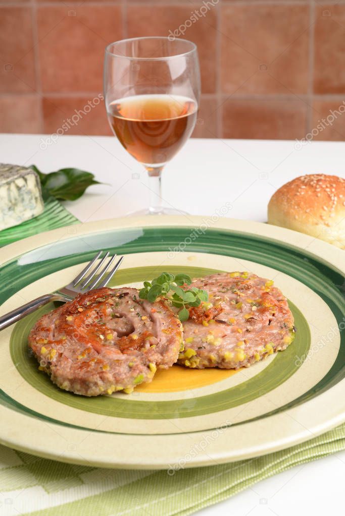 Swivels minced meat with ham and cheese on the table