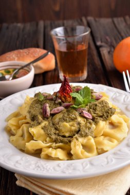 Fıstık krem ve acı biber masada beyaz tabakta Cappelletti makarna