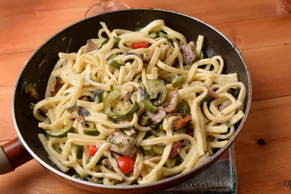 Fettuccine with mussels fish and zucchini in the pan