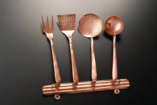 Copper Kitchen cutlery on a black background