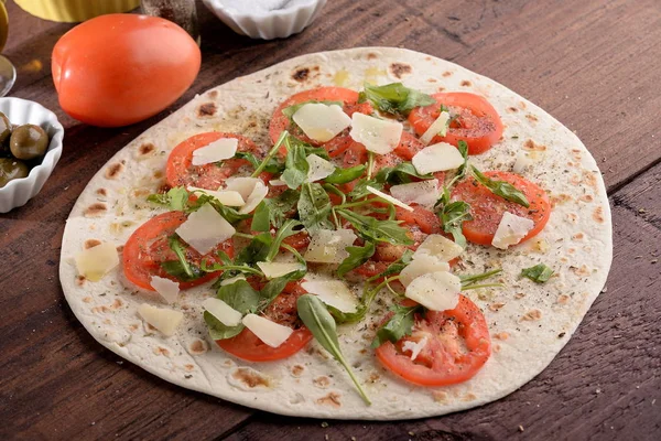 Piadina seasoned tomato grain and rocket — Stock Photo, Image