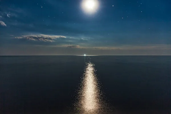 Sea coast, night, moon, stars.
