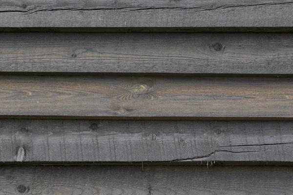 Exterior cladding of a house from boards impregnated with machine oil