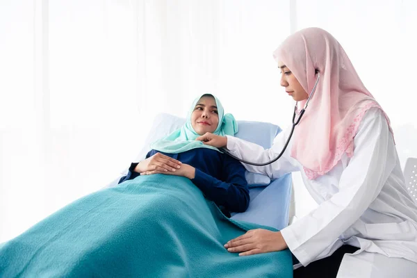 Muslim doctor using stethoscope listen heartbeat.