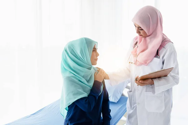 Muslim doctor worm touch on hand patient.