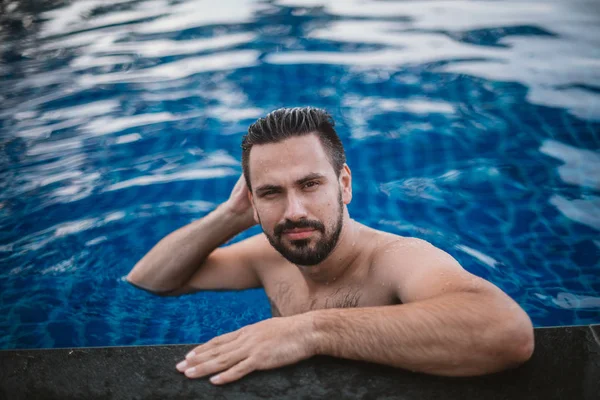 屋外プールで若いハンサムな男の肖像画 プールの側でひげを持つ魅力的な男 — ストック写真