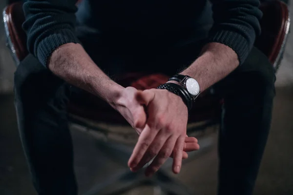 Close-up of strong male hands in watches. Gestures