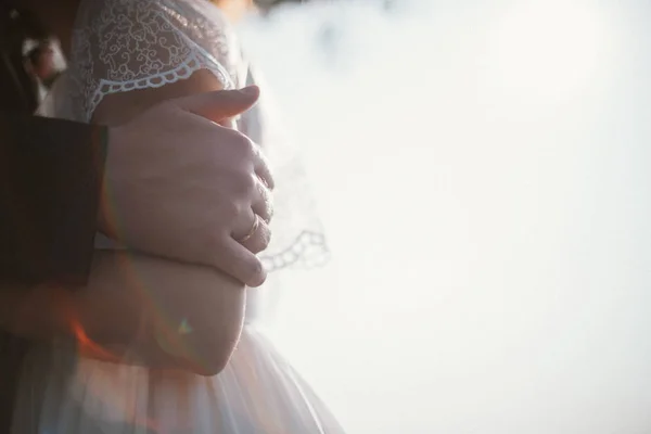 The groom hugs the bride. Closeup of hands — Stock Photo, Image