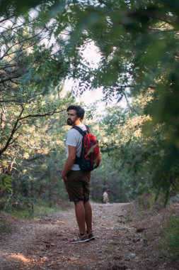 Bir sırt çantası bir yürüyüş gezisi dağlarda olan genç bir adam.