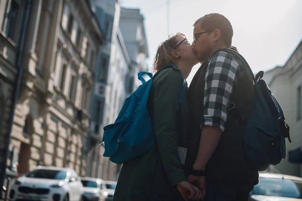 Um jovem casal de amantes está andando pela cidade, beijando . — Fotografia de Stock