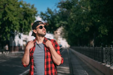 Bir adam turist bir sırt çantası ile sokaklarda yürür