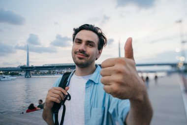 Genç erkek turist kadar jest başparmak gösterir