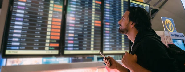 Man Scoreboard Airport Young Guy Backpack Looks Flight Schedule Screen — Stock Photo, Image