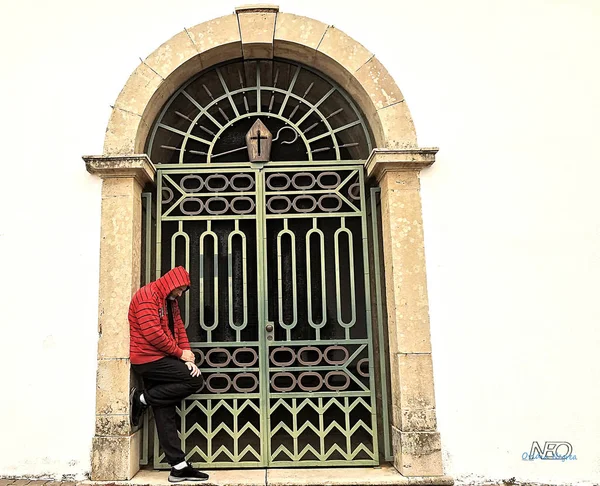 Man with red jacket in a portal