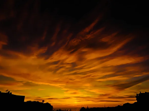 Dramatic sky at the ocean after sunset in Ericeira