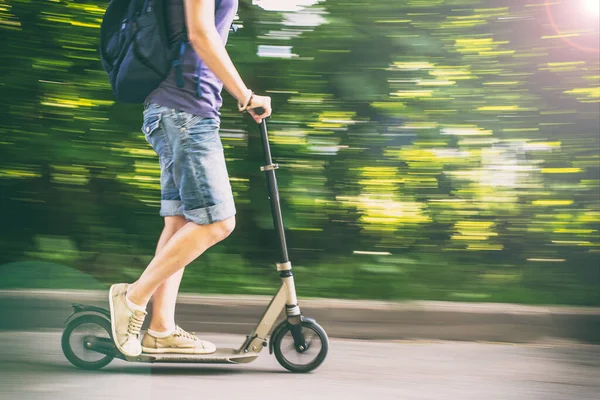 Female Rides Scooter Speed Road Blurred Background Green Trees — Stock Photo, Image