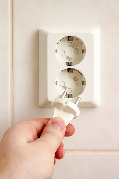 Man Hand Insert Plug Electrical Outlet Protected Children Safety Pads — Stock Photo, Image