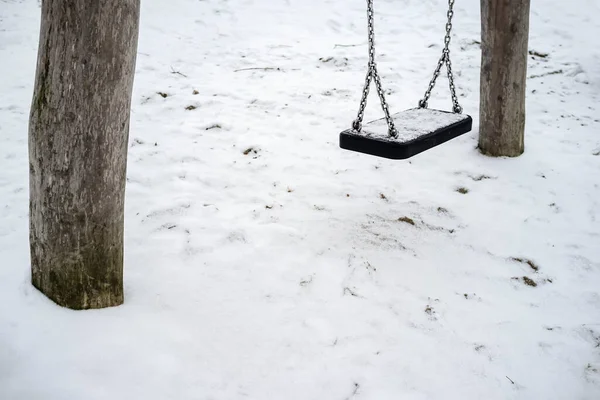 Swings Filled Fresh Snow Deserted Playground Cloudy Spring Day — Stock Photo, Image