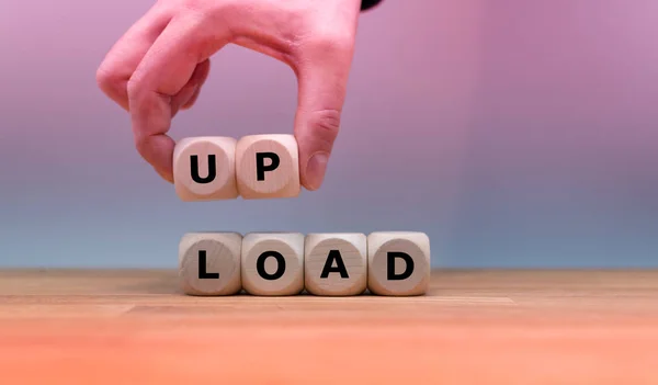 Dice built the word "UPLOAD" while a hand lifts the letters "UP" — Stock Photo, Image