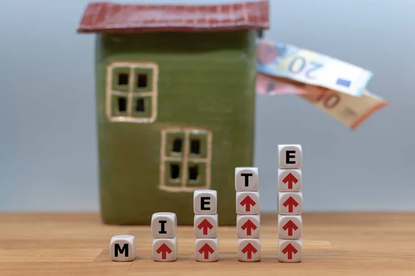 Símbolo para aumentos de alquiler. Los dados forman la palabra alemana "Miete" ("r —  Fotos de Stock