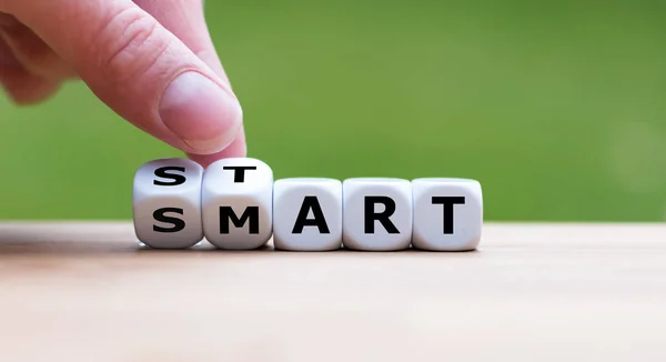 Hand turns dice and changes the word "start" to "smart". — Stock Photo, Image