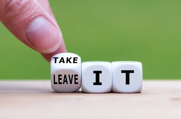 Hand turns a dice and changes the expression "leave it" to "take — Stock Photo, Image