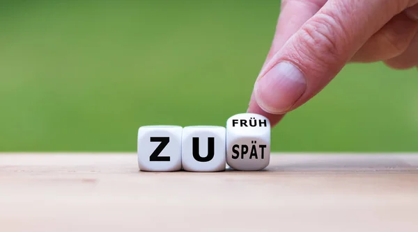 Hand flips a dice and changes the German expression "zu spaet" ( — Stock Photo, Image