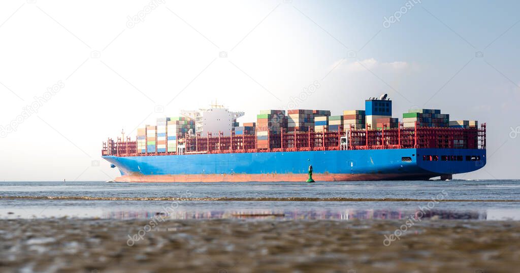 A huge container ship on the river Elbe near Cuxhaven, Germany.