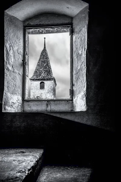 Rrom within one of the towers of the Castle of Gruyere or more properly, looking out at another corner and tower of the Castle of Gruyere.