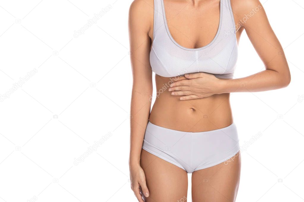 Young woman with a stomachache on white background